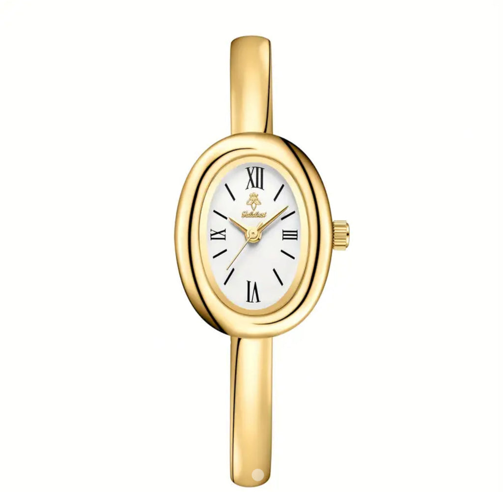 Oval Dial Paired with a Polished Gold Bangle .